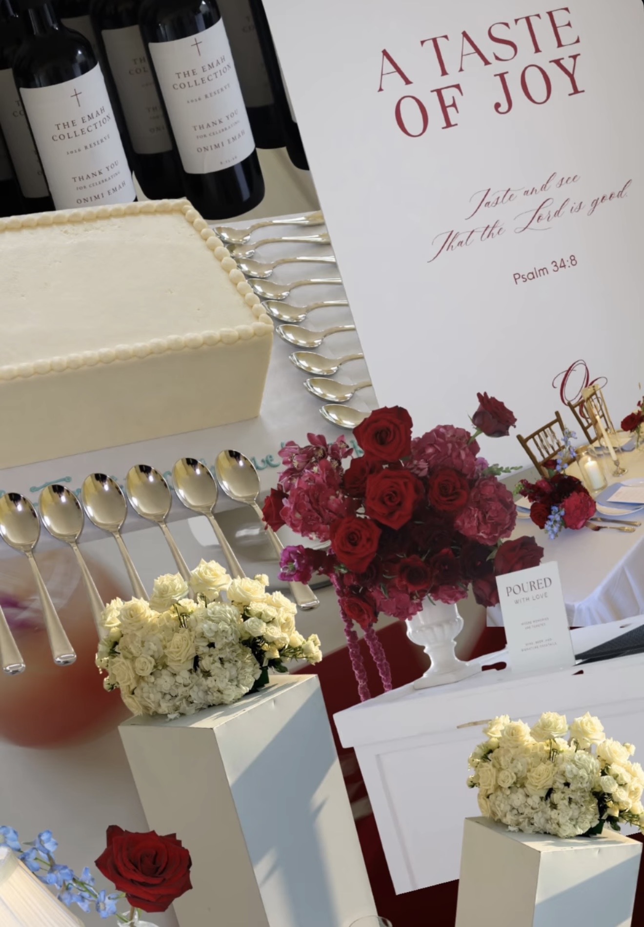 An editorial composite of the hospitality details: a printed A Taste of Joy sign quoting Psalm 34:8, a square buttercream cake edged with rows of silver spoons, Emah Collection wine bottles, an urn of deep red and pink roses, a Poured with Love card, and white rose and hydrangea arrangements on white plinths.